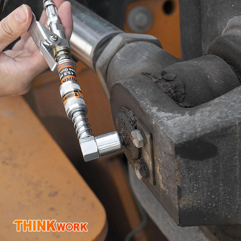 THINKWORK grease gun coupler with 90° adaptor attached to a grease fitting on heavy machinery; silver chrome.