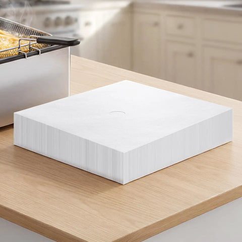 No Sweat Heavy Duty 100 Pack Deep Fryer Filter Papers For Commercial Kitchens 15 By 13 Inch stacked on a kitchen counter.