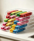 Stackable Drink Packet Organizer with 10 clear acrylic drawers filled with water flavor mixes displayed on kitchen counter.