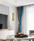Lit Crystal Glass Wall Sconce In Gold Finish, Mid Century Modern Lighting, mounted in modern living room beside curtains and TV.