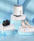 ComXim Motorized Turntable Remote Control Rotating Display Stand 360 Degree Platform showcasing shoes, camera, and appliance on white disks.