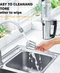 Hand cleaning turbo beaters for hand mixers under running water in kitchen sink