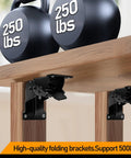 Heavy Duty Folding Brackets 4 Pack Locking Hinge Mounting Screws support 500 lbs with kettlebells on top of a wooden table.