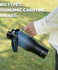 Close-up of Squad Sized 40 Oz Insulated Water Bottle With Straw Lid, featuring ergonomic carrying handles outdoors.