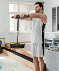 Man using Grip Gains Forearm Wrist Roller Exerciser For Strength Training And Rehab At Home Or Gym Builds Hand Strength And Forearm Power While Boosting Wrist Flexibility For Daily Workouts