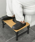 User demonstrating Foldable Adjustable Toilet Stool With Non Slip Layer 7 8 9 Inch Heights Squat Position For Easier Pooping Doctor Recommended Gut Health Boost For Adults Kids Pregnant Women And Seniors in bathroom setting.