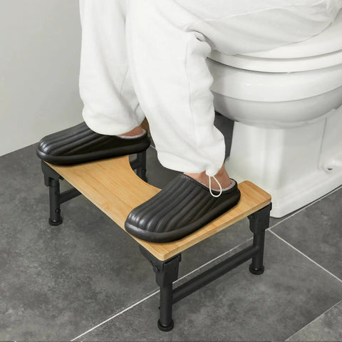 User demonstrating Foldable Adjustable Toilet Stool With Non Slip Layer 7 8 9 Inch Heights Squat Position For Easier Pooping Doctor Recommended Gut Health Boost For Adults Kids Pregnant Women And Seniors in bathroom setting.