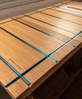 Wooden workbench with blue aluminum 3 Inch T Track Intersection Kit with predrilled mounting holes and wood screws for DIY woodworking jigs.