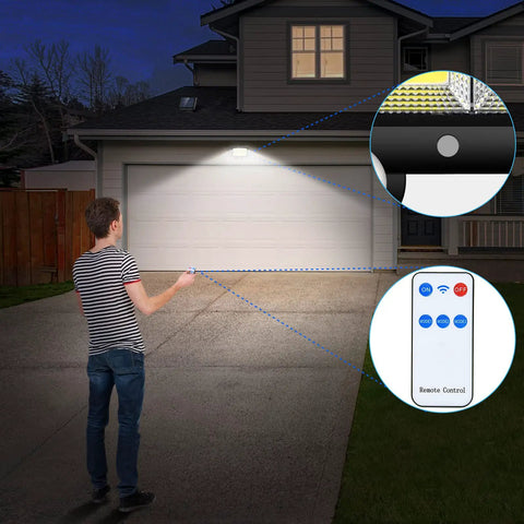 Man using Ultra Bright Solar Motion Lights Outdoor With Remote Control to illuminate a garage with 320 COB LEDs.
