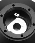 Detailed view of Power Heavy Slick Short Steering Hub Quick Release Adapter Aluminum, showing dual spring locking mechanism for trucks.