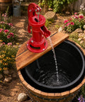 Old School Cast Iron Hand Water Pump For Wells And Gardens Antique Pitcher Pump in garden setting with wooden barrel base