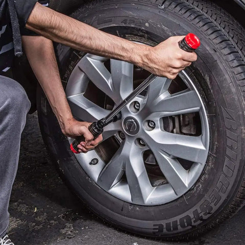 User using Billy Club Universal Lug Wrench For Quick Tire Changes And Break Loose Lug Nuts on car tire