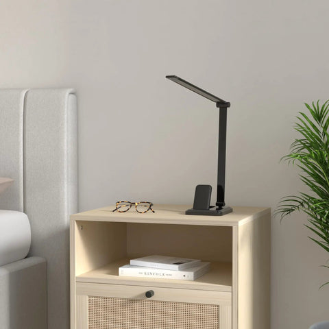 Black LED Desk Lamp With Wireless Charger And USB Port, Touch Control, Eye Care, on a wooden nightstand in a modern bedroom.