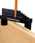 Milescraft CenterFinder front view: black center-scriber tool clamped to wood edge with orange pencil