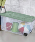 Heavy Duty Rolling Storage Bins, 40 Gallon Capacity, 2 Pack Garage Organization Cart With Wheels, Hella Tough Mobile Container For Moving Supplies, Workshop Tools, And Camping Gear, Green Sage holding toys.