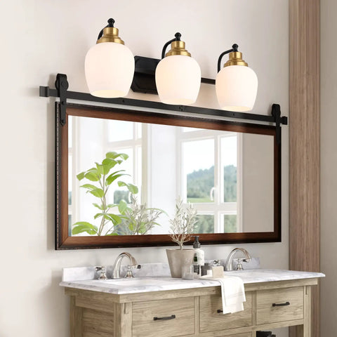 Bold Black And Gold 3 Light Vanity Light Fixture With White Glass Globe in bathroom setting above mirror