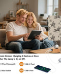 Couple using Cowboy Watercolor Decor Bedside Lamp With 3-Way Dimmable Touch Control And Built-In Charging Station with devices.