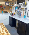 Workshop interior with tools, pegboard, and a countertop, featuring Straight Up Charred Aging Wood Stain For Interior Projects.