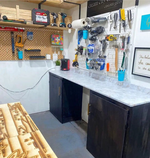 Workshop interior with tools, pegboard, and a countertop, featuring Straight Up Charred Aging Wood Stain For Interior Projects.