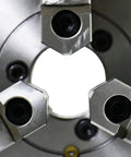 Close-up view of Top Shelf Eight Inch Three Jaw Self Centering Scroll Lathe Chuck, showcasing three jaws and steel construction.