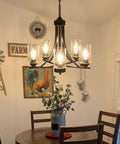 Five Light Black Glass Chandelier With Rustic Metal Pendant Lighting illuminating a dining area.