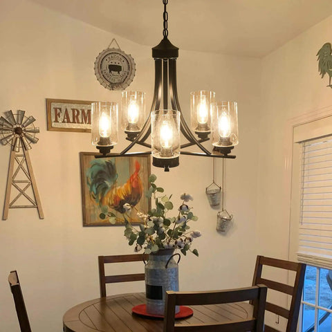 Five Light Black Glass Chandelier With Rustic Metal Pendant Lighting illuminating a dining area.
