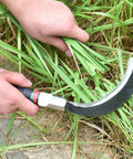 Two Pack Manganese Steel Garden Weeders with Ergonomic Handles used for cutting grass close-up in garden