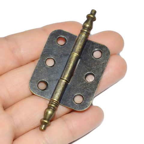 Top Shelf Vintage Folding Hinges With Screws Rock Solid Antique Bronze Zinc Alloy Hardware For Diy Projects, held in hand.
