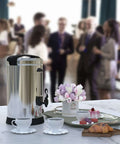 Heavy Duty 18 Liter Coffee Urn That Brews 120 Cups Stainless Steel Commercial Coffee Maker And Electric Hot Beverage Dispenser For Catering And Events Ultra Large Capacity For Offices Restaurants Churches Parties on a table at an event