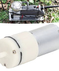 Miniature Vacuum Pump 6V Micro Air Pump Aluminum Diaphragm Pump With Pressure Switch And Relief Valve For Aquariums And Home Appliances Self Priming Sprayer Pump Low Noise Dual 90 Degree Air Ports shown outdoors with hose attached.
