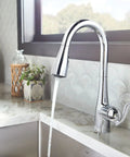 Arbor Chrome One-Handle Kitchen Faucet with Pull Down Sprayer Featuring Power Boost and Reflex in use at a modern kitchen sink
