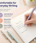 Person writing in notebook with 7 Pack Gel Pens 0.5mm Quick Dry Black Ink For Smooth Writing Retractable Ballpoint Pens Office And School Supplies Must Have Premium Morandi Style Set For Notes Journaling And Everyday Use
