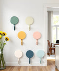 Set Of Ten Peel And Stick Wall Hooks Featuring Strong Adhesive Grip Easy Peasy Peel Backing For Bathroom Organization Decorative cute circular designs on a wall.