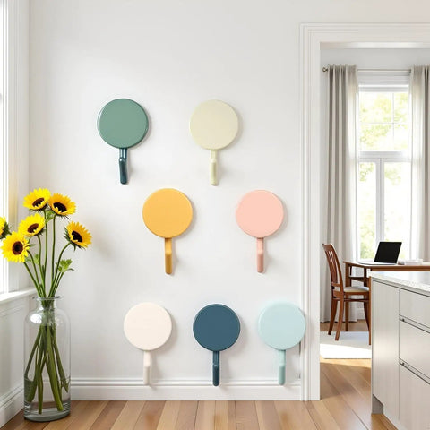 Set Of Ten Peel And Stick Wall Hooks Featuring Strong Adhesive Grip Easy Peasy Peel Backing For Bathroom Organization Decorative cute circular designs on a wall.