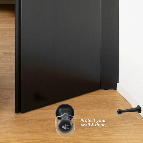 Super Sturdy Three Inch Heavy Duty Door Stops In A Spiffy Twelve Pack Featuring Dang Tough Solid Zinc Alloy Build And A Sleek Matte Black Finish To Safeguard Your Walls With Zero Fuss, positioned against door.