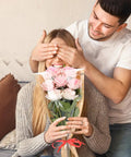 Woman holding bouquet in 40 Pack Kraft Paper Flower Wrapping Bags And Sleeves For Bouquets with man covering her eyes