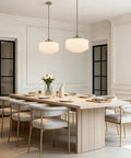 Vintage Brass Milk Glass Pendant Light 13.8in White Pleated Chandelier, E26 illuminating a modern dining space with elegant decor.