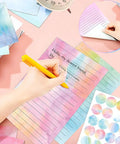 Must Have All In One Letter Writing Stationery Set With 50 Lined Papers And 50 Matching Envelopes Plus 60 Sealing Stickers In A 5.5 By 8.25 Inch Watercolor Design For Home Office And School, shown with person writing on watercolor paper.