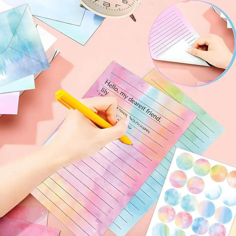 Must Have All In One Letter Writing Stationery Set With 50 Lined Papers And 50 Matching Envelopes Plus 60 Sealing Stickers In A 5.5 By 8.25 Inch Watercolor Design For Home Office And School, shown with person writing on watercolor paper.