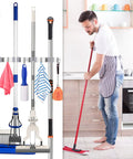 Heavy Duty Wall Mount Broom Holder And Tool Organizer Set With 3 Racks And 4 Hooks Metal Garage Storage for brooms, with man using mop