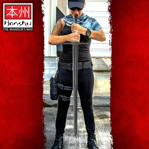 Person holding Polypropylene Bokken Training Sword Broadsword 43.5 Inch Blunt Practice Weapon For Sparring Realistic Balance And Beefy Weight Built Tough And Nearly Indestructible Safe Martial Arts Gear For Training Sparring And Cosplay outdoors