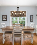 Dining room with Wagon Wheel Chandelier For Dining Room, 6 Light Farmhouse Pendant With Wood Grain Finish hanging over table.