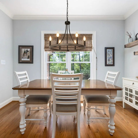 Dining room with Wagon Wheel Chandelier For Dining Room, 6 Light Farmhouse Pendant With Wood Grain Finish hanging over table.