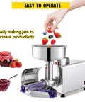 Premium 220 Stainless Steel Commercial Electric Food Strainer And Press Machine For Puree, Sauce, And Juice Making with fresh berries being added.