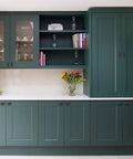 Modern kitchen with green cabinets featuring 2 pack matte black cabinet pulls T bar knobs for kitchen cupboards and bathroom cabinets.