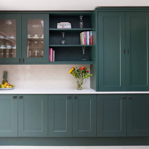 Modern kitchen with green cabinets featuring 2 pack matte black cabinet pulls T bar knobs for kitchen cupboards and bathroom cabinets.