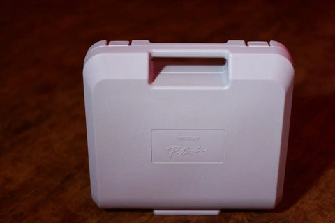 White carrying case for Pro Grade PT 2700 Desktop Labeling System with handle, suitable for 99-label storage and transport.