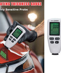 Coating Thickness Meter 0 To 2000 Um Digital Gauge For Automotive Paint, Car Coating Thickness Tester, 0.1 Um Mil Thickness Gauge For Used Car Buyers, Non Destructive Coating Gauge For Auto Body, Shop And Lab. Handheld white digital gauge measuring car paint thickness