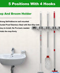 Heavy Duty Wall Mount Mop And Broom Holder With Five Slots And Four Hooks Self Adhesive Stainless Steel Organizer installed on wall
