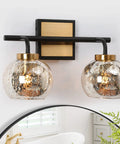 Modern Vanity Light Over Mirror With Mercury Glass Shades In Black And Gold Finish For Bathroom Dope Fixture That Delivers A Warm Soft Glow Perfect For Makeup Area And Powder Room Vanity Lighting featured with two mercury glass shades and black and gold square backplate.